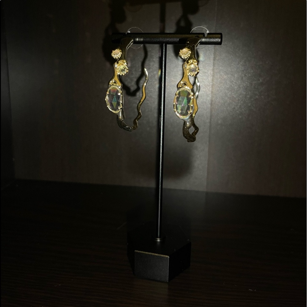 Gold Kendra Scott hoop earrings.